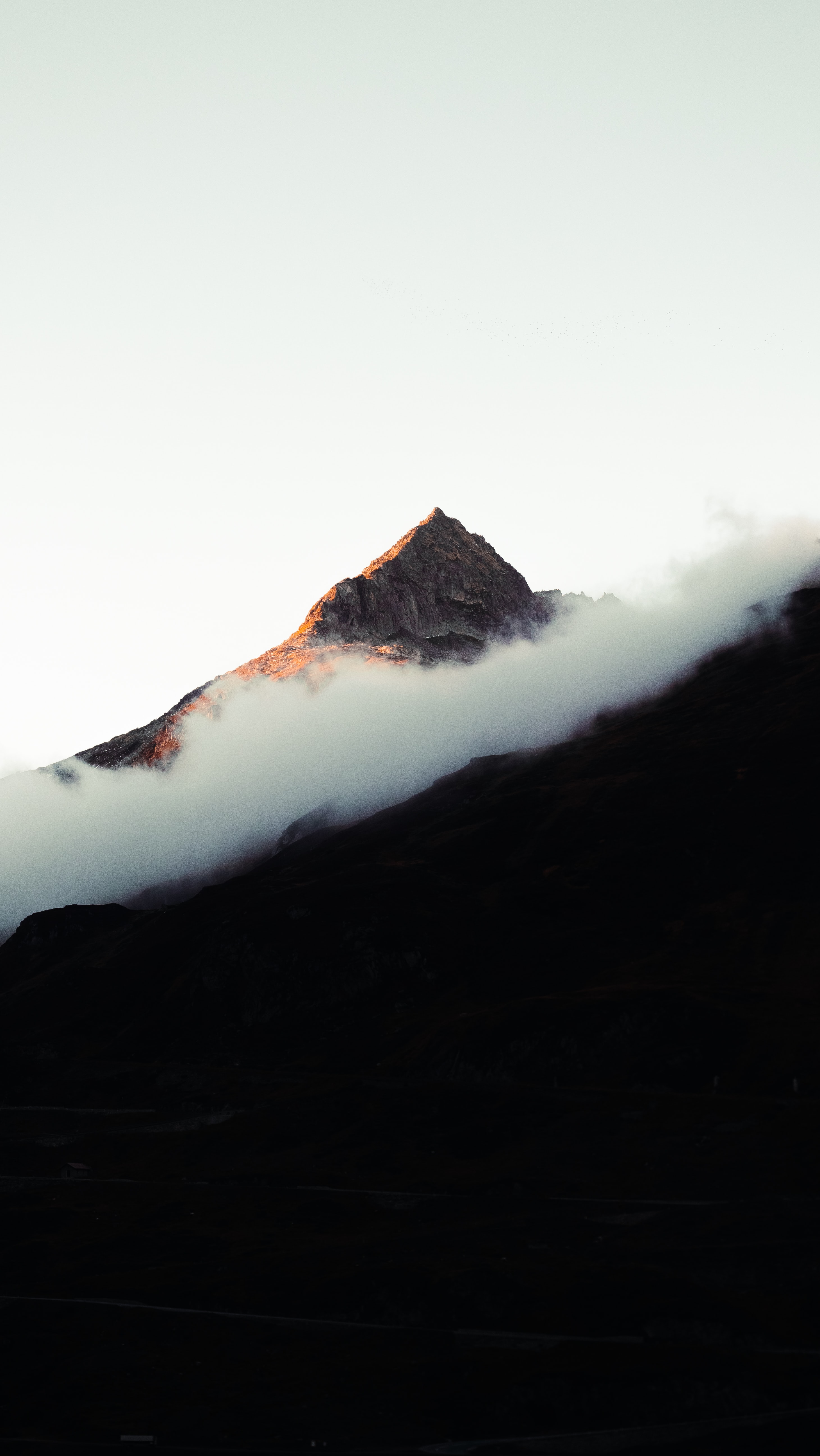 a_mountain_with_clouds_in_the_sky.jpg